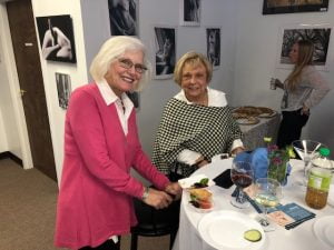 Two women smiling for camera at charity event