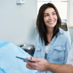 Woman talking with plastic surgeon during a mommy makeover consultation