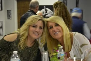 Two women smiling for camera at charity event