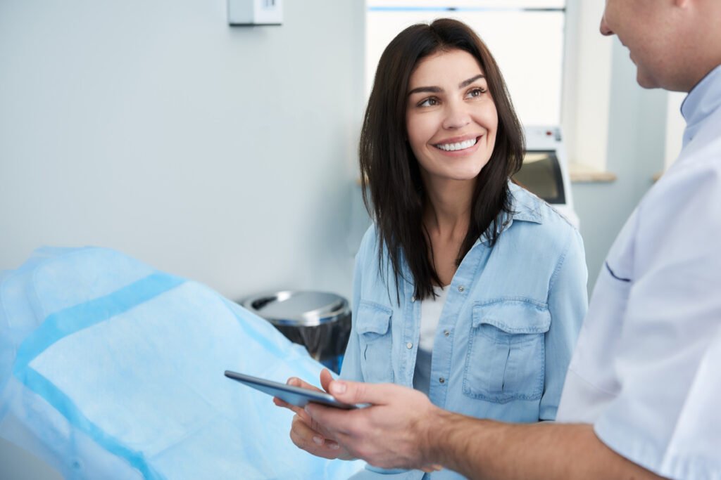 Woman talking with plastic surgeon during a mommy makeover consultation