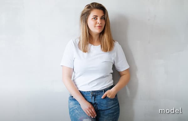 Lower Body Lift (Belt Lift) model image of woman wearing a white t-shirt and jeans posing for the camera
