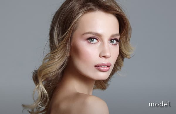 Botox® Cosmetic (Neuromodulator) model of woman looking over shoulder at camera