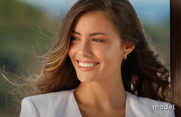 Daxxify (Neuromodulator) model of woman wearing a white blazer looking away from camera