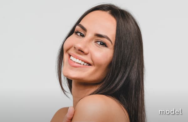 Laser hair removal model with brown hair smiling looking at camera