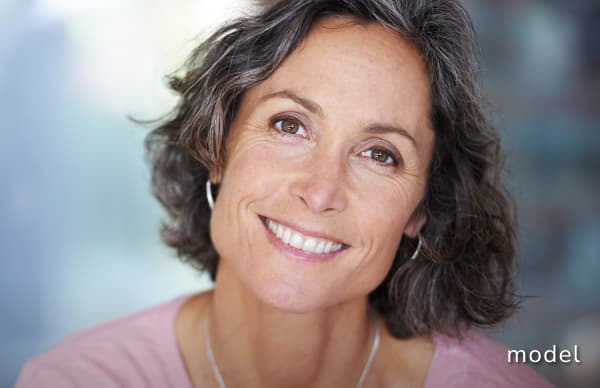 Cutera Lasers for Skin Resurfacing: excel V & Genesis model of woman smiling at camera