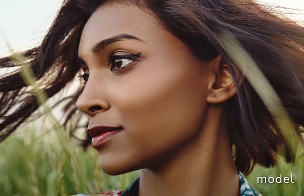 Revision Rhinoplasty (Secondary Rhinoplasty) model of woman outside in field looking away from camera