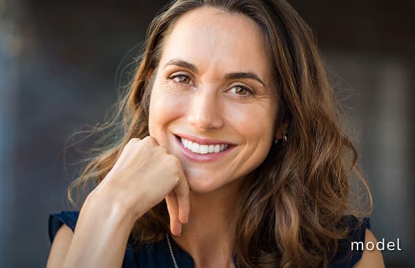 Sculptra Dermal Filler model of woman sitting and smiling for camera