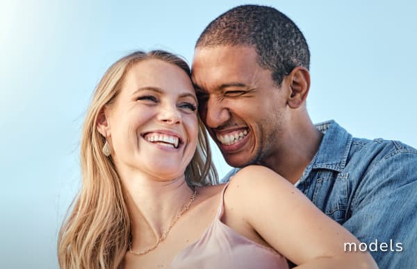 Ear Surgery Otoplasty Ear Pinning models of young man and woman smiling showing affection