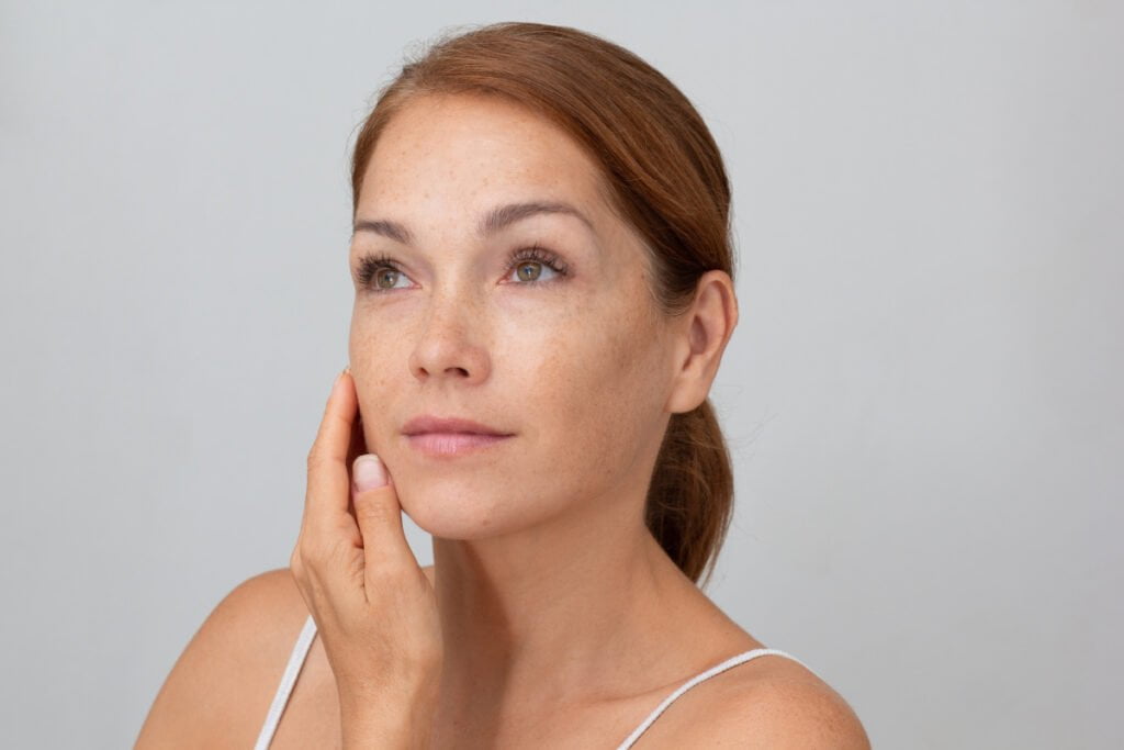 Mature woman touching her face