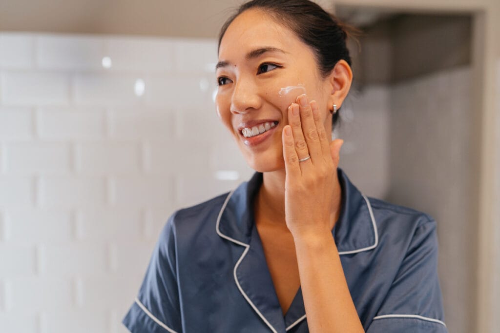 Woman applying skincare before bed