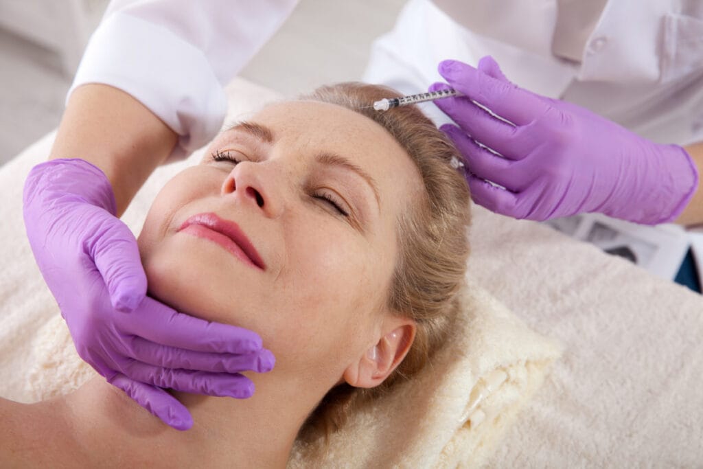 Mature woman getting Botox injections to prepare for upcoming event
