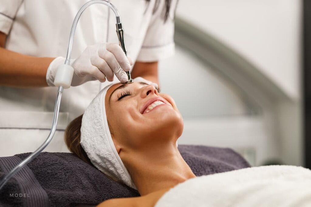 Woman getting professional microdermabrasion treatment at a med spa