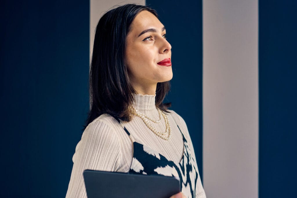 Transgender woman in office clothes looking off and feeling empowered after top surgery