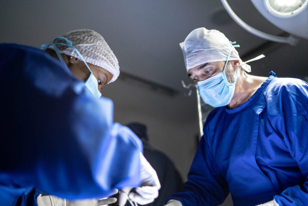 Two surgeons in operating room during cosmetic surgery procedure